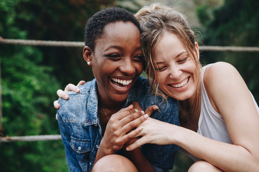 happy friends holding each other