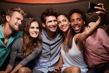 happy friends taking self portrait at nightclub