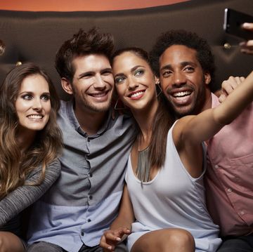 happy friends taking self portrait at nightclub