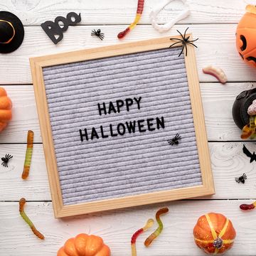 happy halloween words on gray letter board with candy flat lay,romania