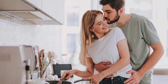 happy lovers cooking food and showing their feelings