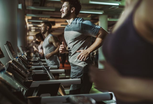 https://hips.hearstapps.com/hmg-prod/images/happy-male-athlete-running-on-treadmill-in-a-gym-royalty-free-image-1727356677.jpg?crop=1xw:0.73445xh;center,top&resize=640:*