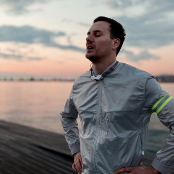 happy man breathing deeply fresh air by the seashore