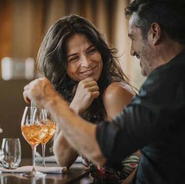 happy mature couple enjoying drink in restaurant