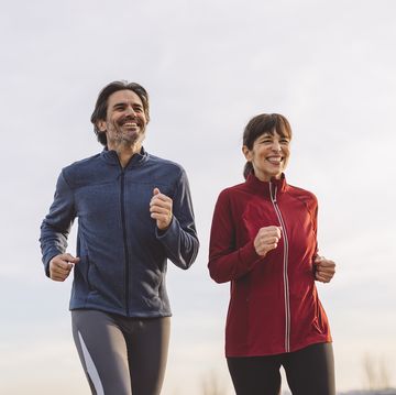 happy mature man and woman running Palm together