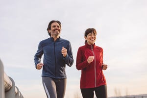 happy mature man and woman running together