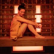 happy mid adult woman in sauna relaxing