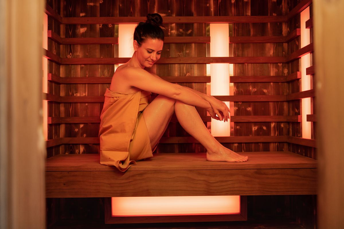 happy mid adult woman in sauna relaxing