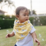 happy moment asian baby girl positive emotion enjoyment and playful with bubble on playground with mother in the garden domestic life