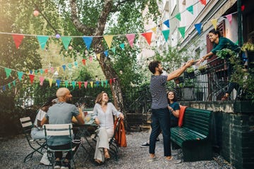 happy multi ethnic friends in backyard during garden party