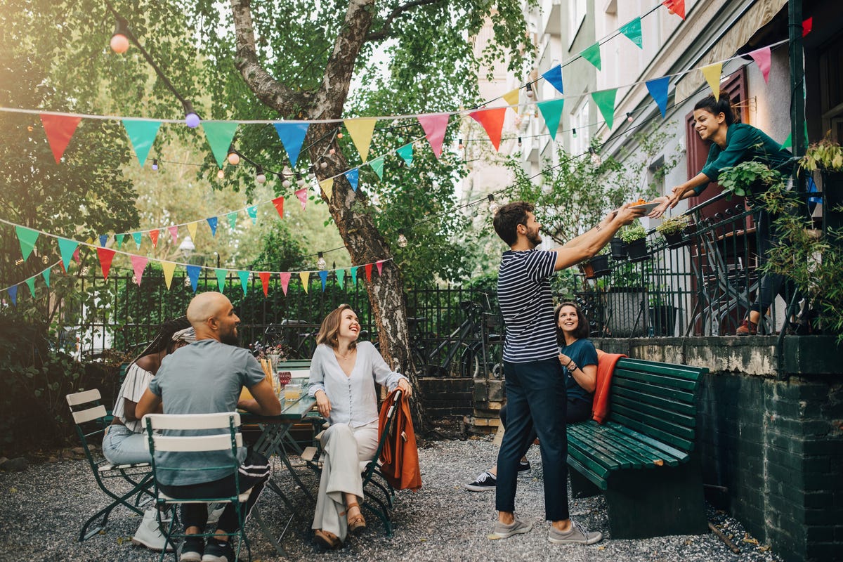 happy multi ethnic friends in backyard during garden party