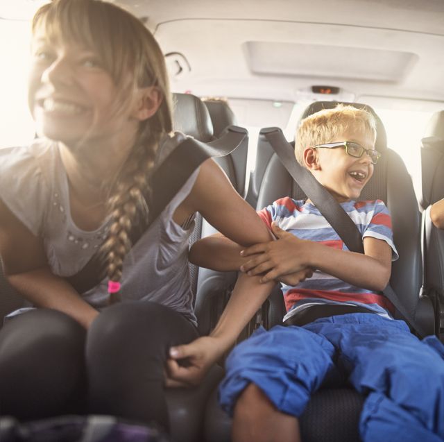 happy playful kids travelling by car