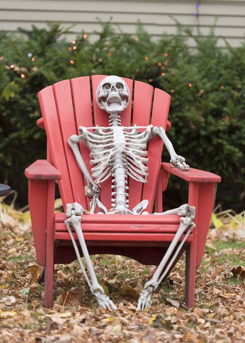 happy skeleton sitting in a chair