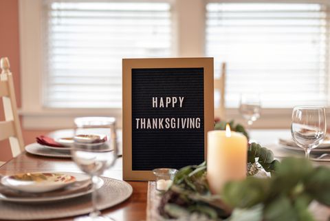 Happy Thanksgiving letterboard on dining room table decorated for dinner party