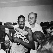 red auerbach hugging bill russell at press conference