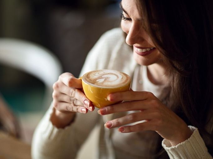 https://hips.hearstapps.com/hmg-prod/images/happy-woman-enjoying-in-cup-of-fresh-coffee-royalty-free-image-1587051461.jpg?crop=0.892xw:1.00xh;0.0555xw,0&resize=768:*