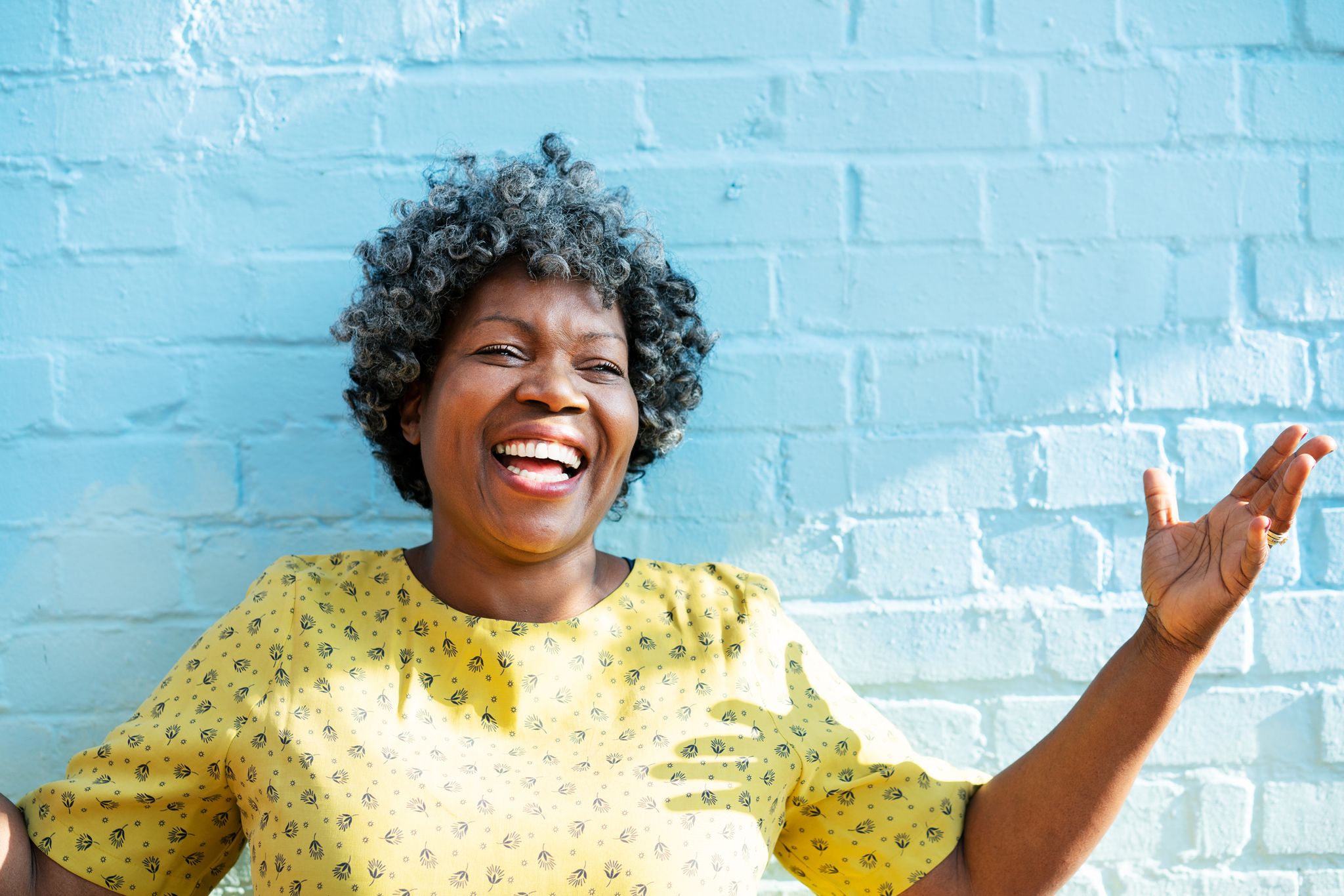 happy woman laughing with arms up