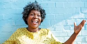 happy woman laughing with arms up