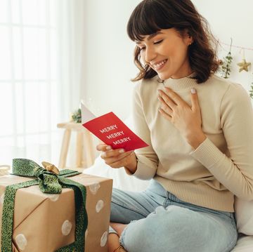 happy woman reading a christmas greeting card