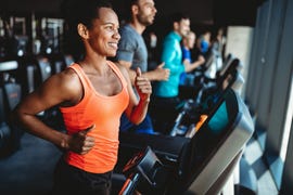 happy woman smiling and working out in gym, treadmill workouts
