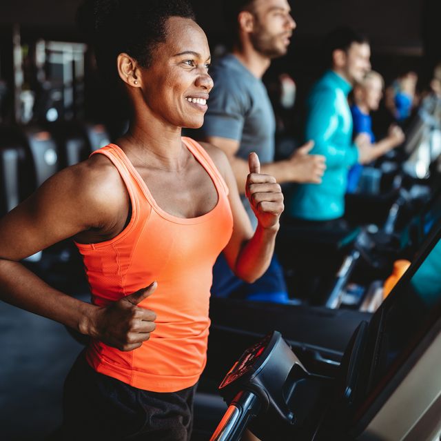 happy woman smiling and working out in gym, treadmill workouts