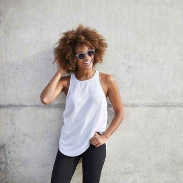 happy woman wearing tank top and sunglasses