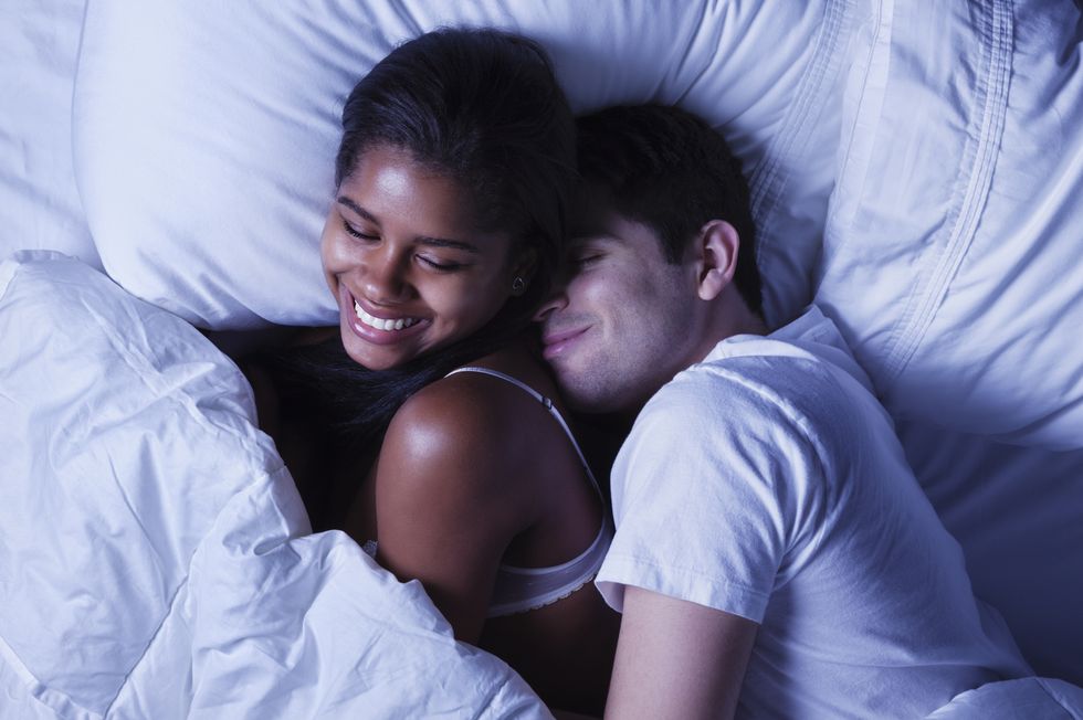 Happy Young Couple in Bed