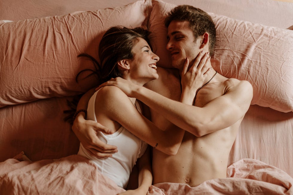 happy young couple lying in bed