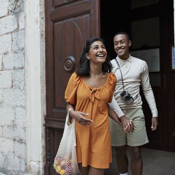 happy young couple walking out of doorway