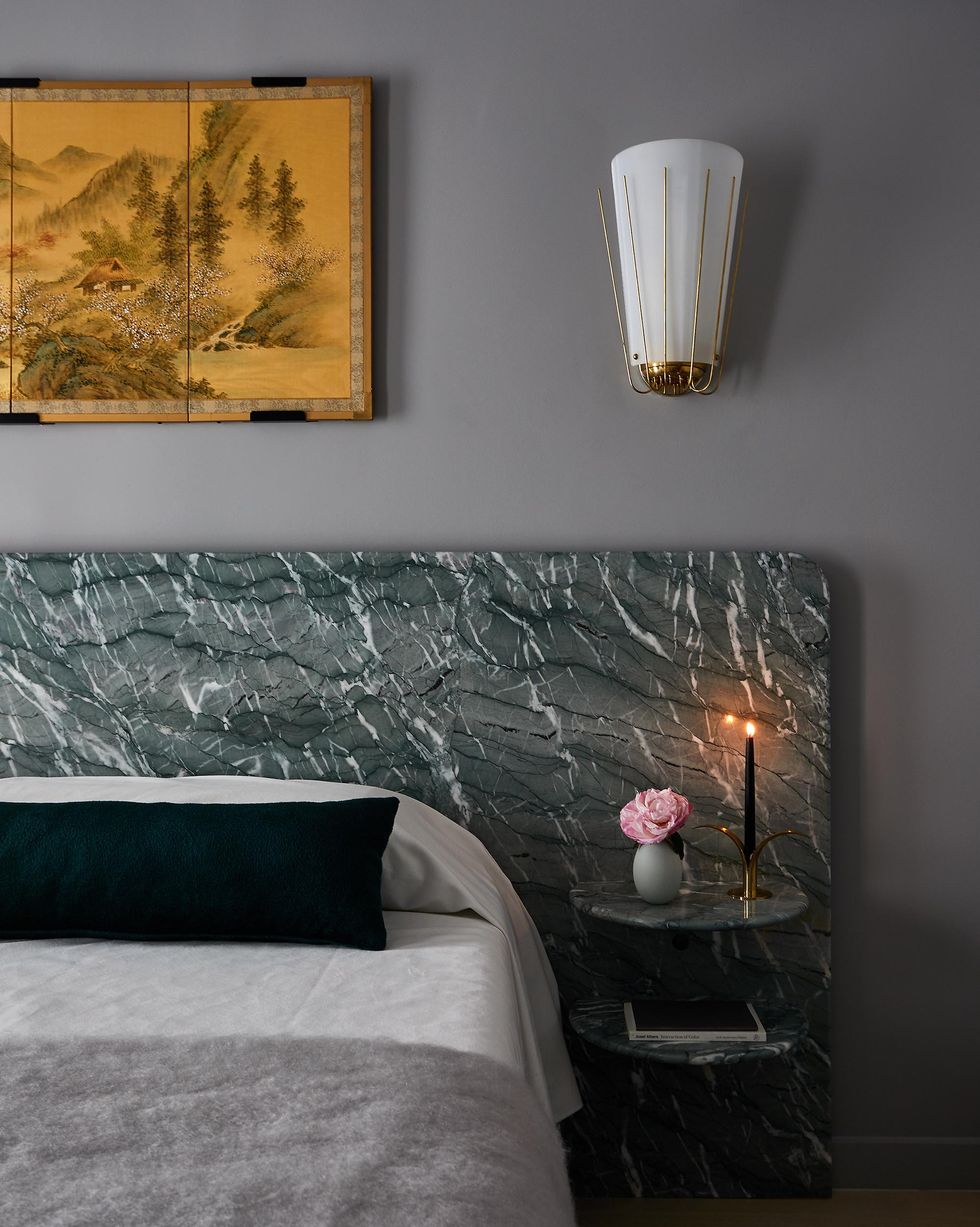 the bedroom of jett projects brooklyn apartment features a bed with a green marble headboard