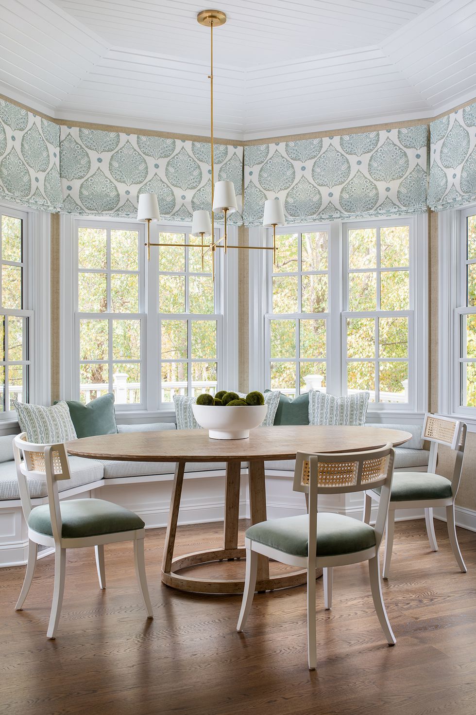a dining room with a table and window seat