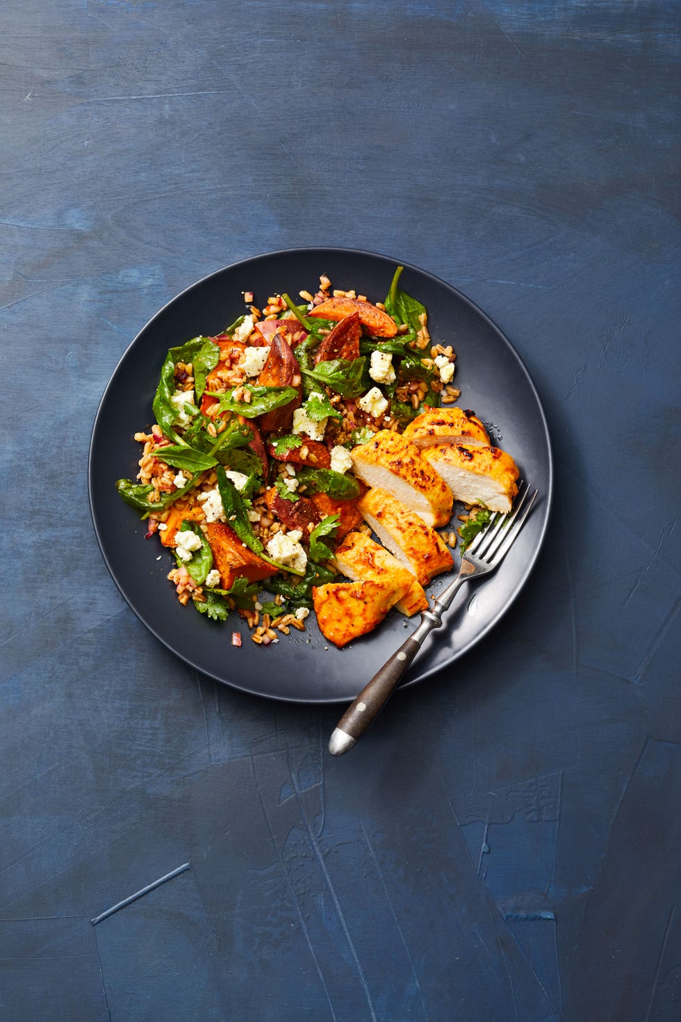 harissa chicken and farro salad on a blue background