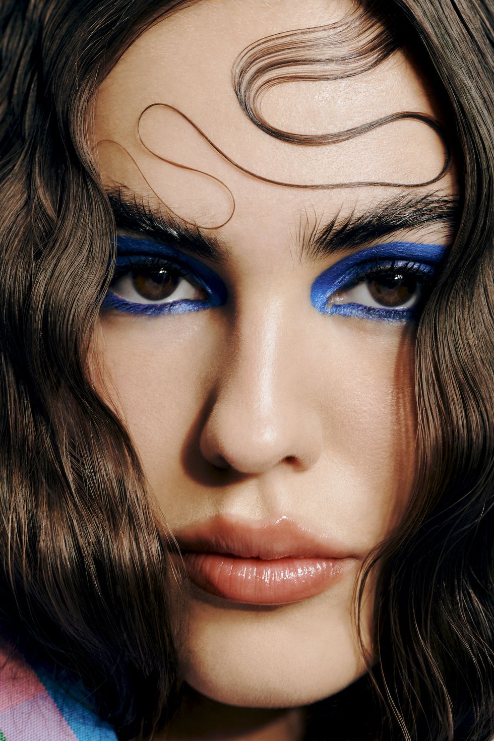 a woman with blue make up in the eyes