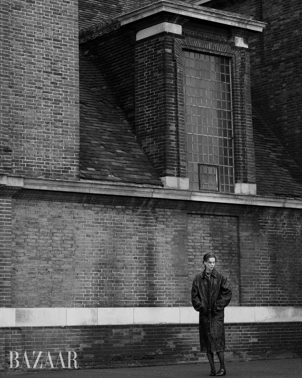 a person standing in front of a brick building