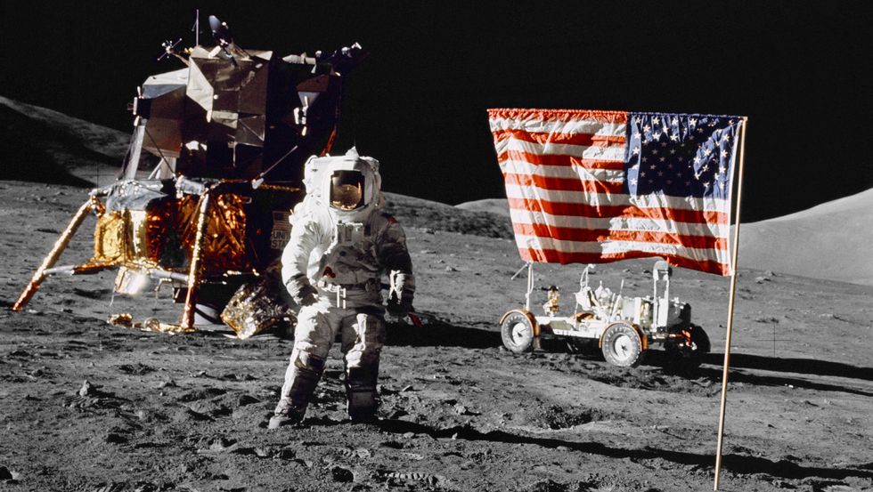harrison h schmitt, pilot of the lunar module, stands on the lunar surface near the united states flag during nasa's final lunar landing mission in the apollo series 13 december 1972 credit nasa science astronaut space travel
