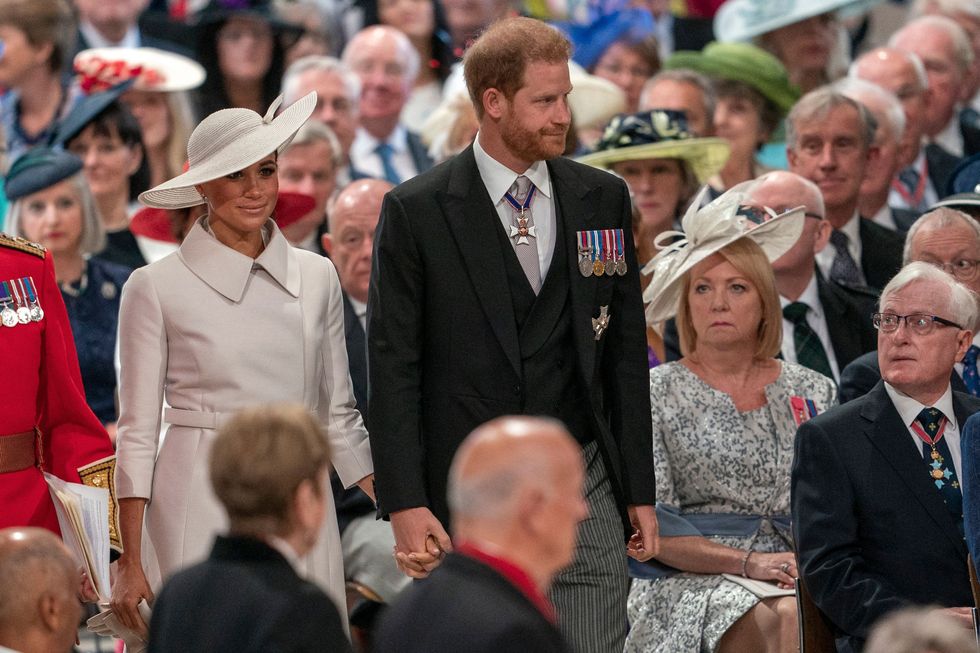 topshot britains prince harry, duke of sussex c and britains meghan, duchess of sussex centre left attend the national service of thanksgiving for the queens reign at saint pauls cathedral in london on june 3, 2022 as part of queen elizabeth iis platinum jubilee celebrations queen elizabeth ii kicked off the first of four days of celebrations marking her record breaking 70 years on the throne, to cheering crowds of tens of thousands of people but the 96 year old sovereigns appearance at the platinum jubilee a milestone never previously reached by a british monarch took its toll, forcing her to pull out of a planned church service photo by arthur edwards pool afp photo by arthur edwardspoolafp via getty images