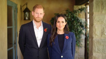 two individuals in formal attire standing close together