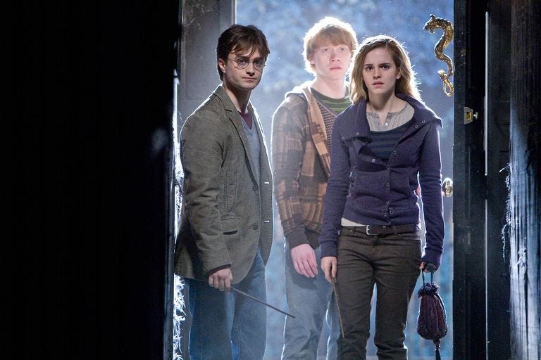 harry, ron and hermione in a still from harry potter and the deathly hallows part 1
