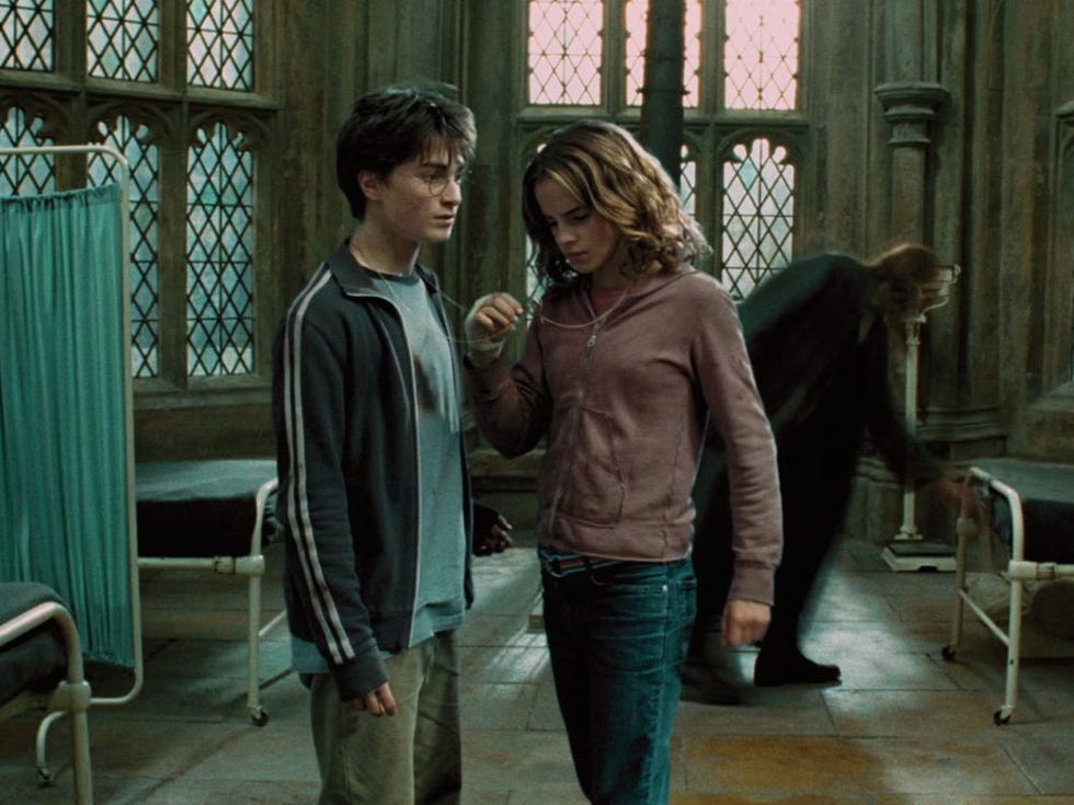 harry and hermione stand in the infirmary wing of hogwarts, holding the timeturner