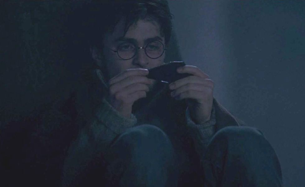 harry potter uses the shard of two way mirror in the deathly hallows