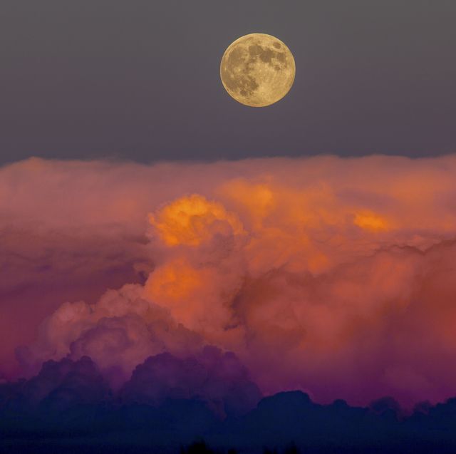 Harvest moon rising above storm clouds, western Colorado.