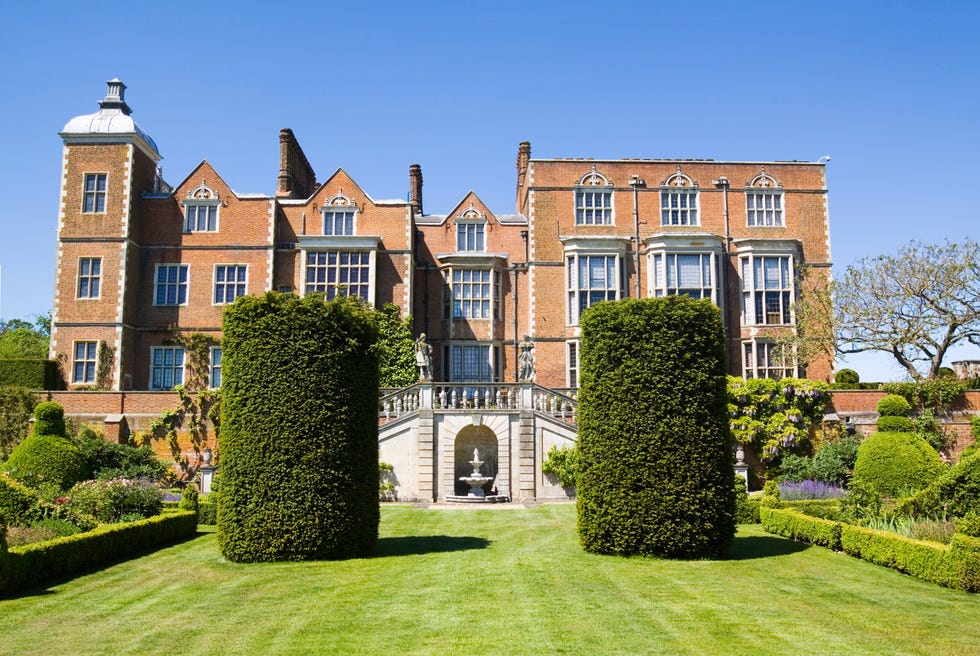 hatfield house is an english stately home set in a large 42 acre park in hertfordshire shown here is the east facade and gardens, which are only occasionally opened the jacobean style mansion was built by robert cecil in 1611 and has remained in the cecil family ever since it’s spectacular location and architecture has made it a must for many films, including shakespeare in love, batman and batman ii, the golden age and many others queen elizabeth i spent much of  her early life in residence at hatfield it is said that it is here where the ‘virgin queen’, whilst said to be sitting under an oak tree in the park in the year of our lord, 1558, learned that she had become queen of england and ireland, following the death of her half sister, mary good copy space