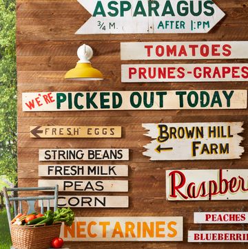 barn side with all sorts of vintage produce and farm stand signs