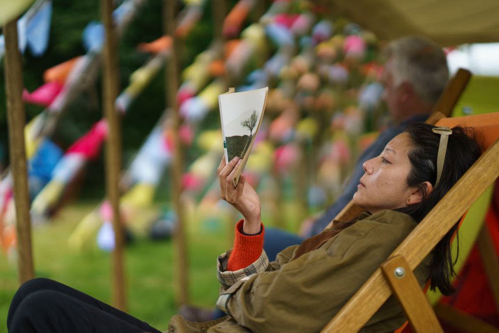 hay on wye, wales june 4 a visitor enjoys reading a book in a tent at the hay festival on june 4, 2022 in hay on wye, wales photo by david levensongetty images