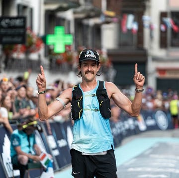 runner celebrating at the finish line of a race runner celebrating at the finish line of a race