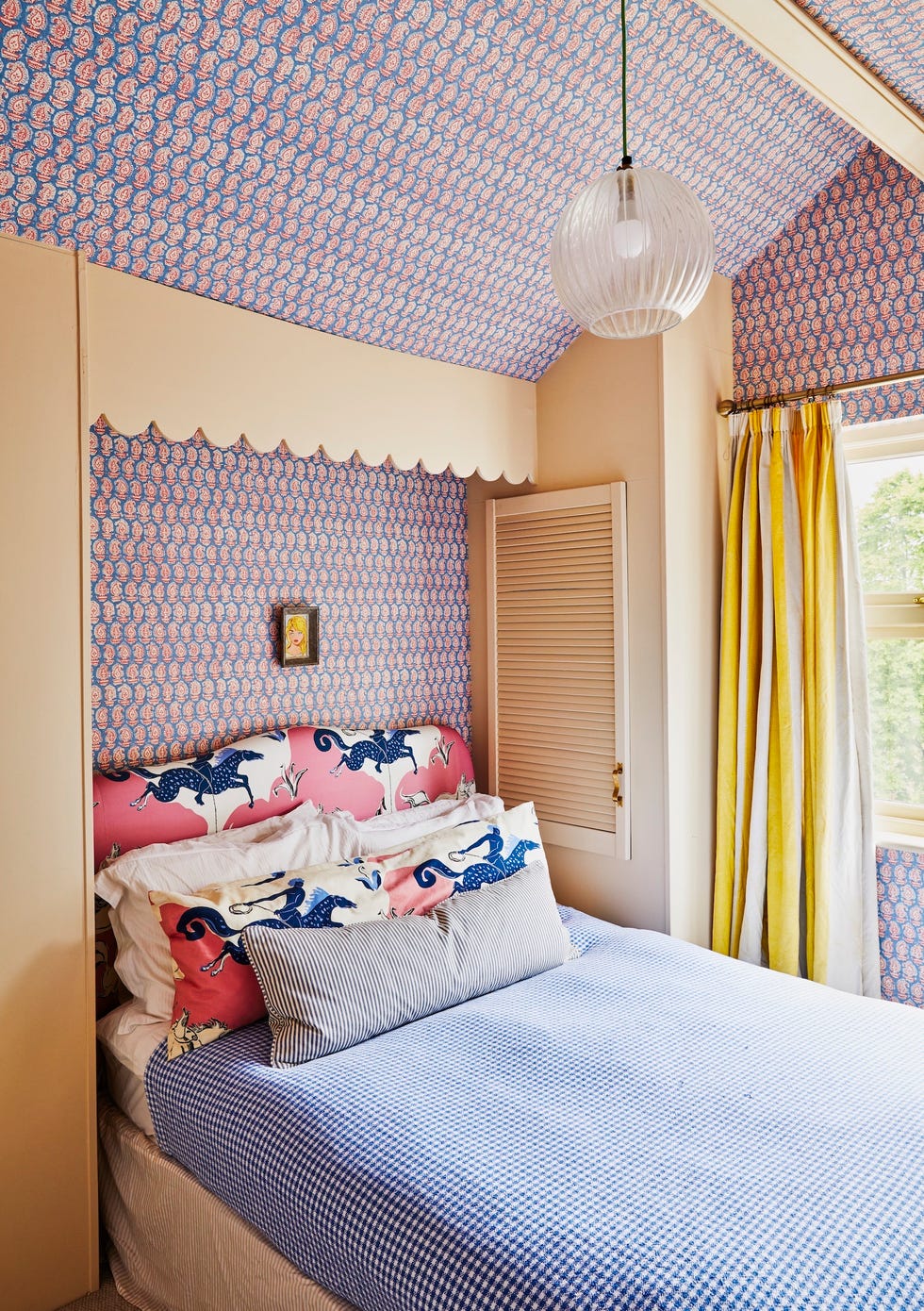 a bed with wallpapered walls and ceiling