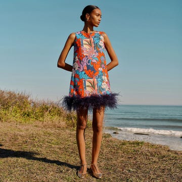 woman wearing colorful shift with purple feathers