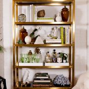 gold bookcase with knick knacks