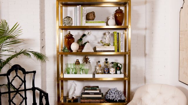 gold bookcase with knick knacks