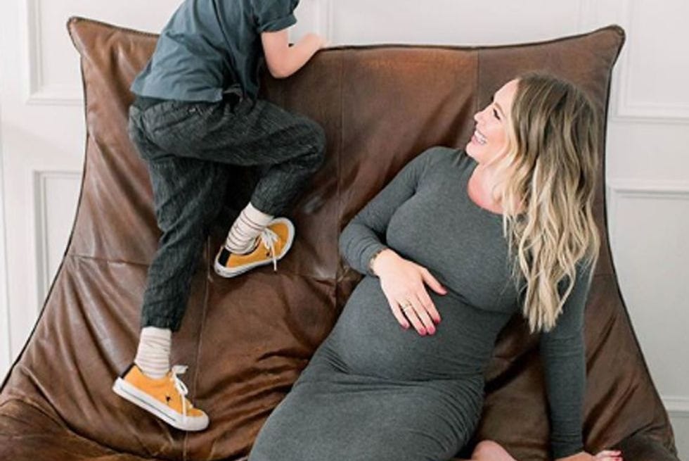 a boy and girl sitting on a couch